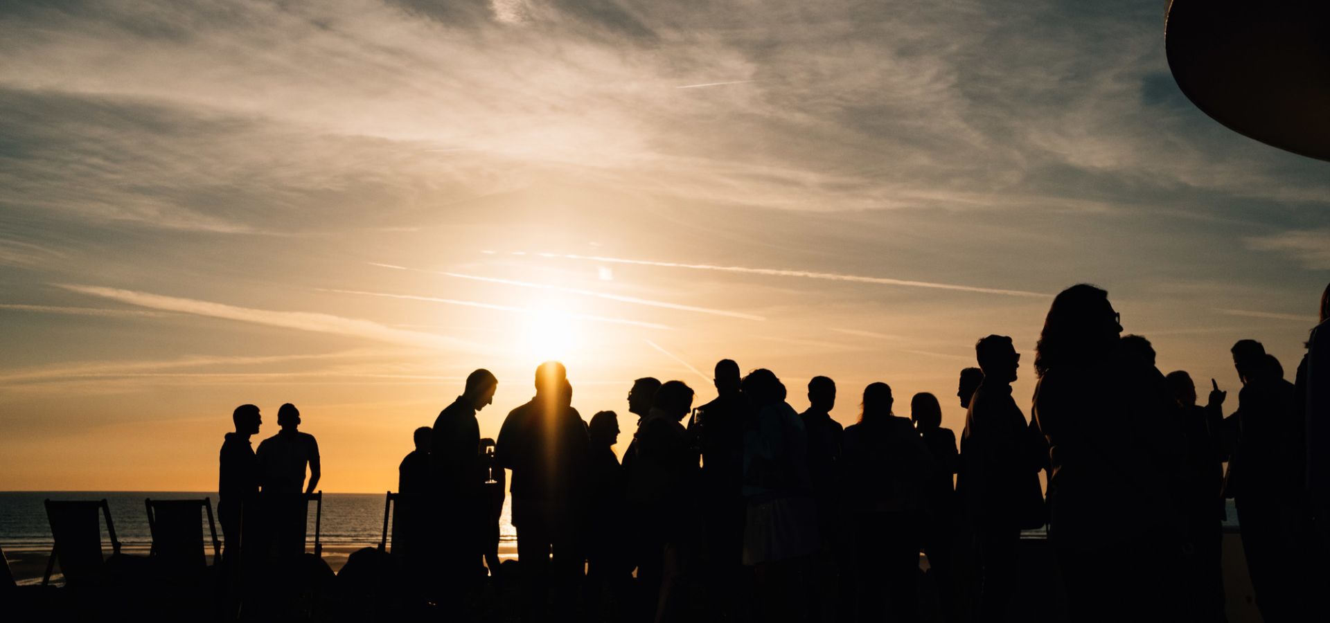 A group of people at El Tico Beach Cantina at sunset