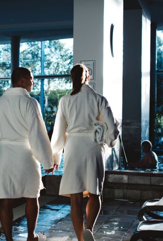 Couple walking next to a spa pool