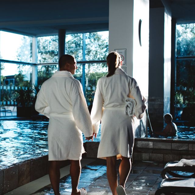 Couple walking next to a spa pool