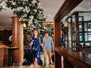 A couple walking into The Club Hotel