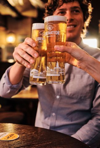 A couple drinking Liberation larger in a Jersey pub