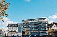 Modern hotel next to an older hotel with blue skies