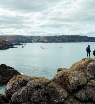 Friends walking on coastal path