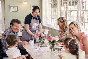 La Hougue Bie Family sit outside having coffee
