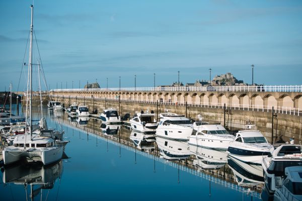 Boats in the St. Helier marina, Jersey, with Elizabeth Castle in the background