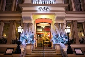 Grand heritage building, with granite entrance steps and illuminated Banjo sign