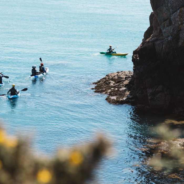 A group kayaking in St. Brelade's Bay