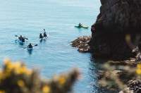 A group kayaking in St. Brelade's Bay