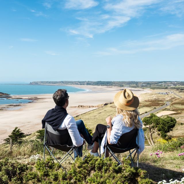 Couple bask in the sun overlooking St. Ouen