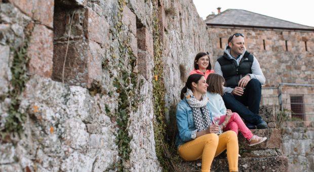 Family sat on steps at Fort Leicester