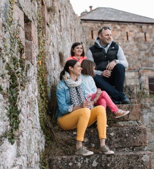 Family sat on steps at Fort Leicester