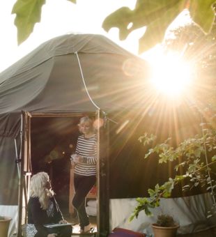 People stood outside glamping pod