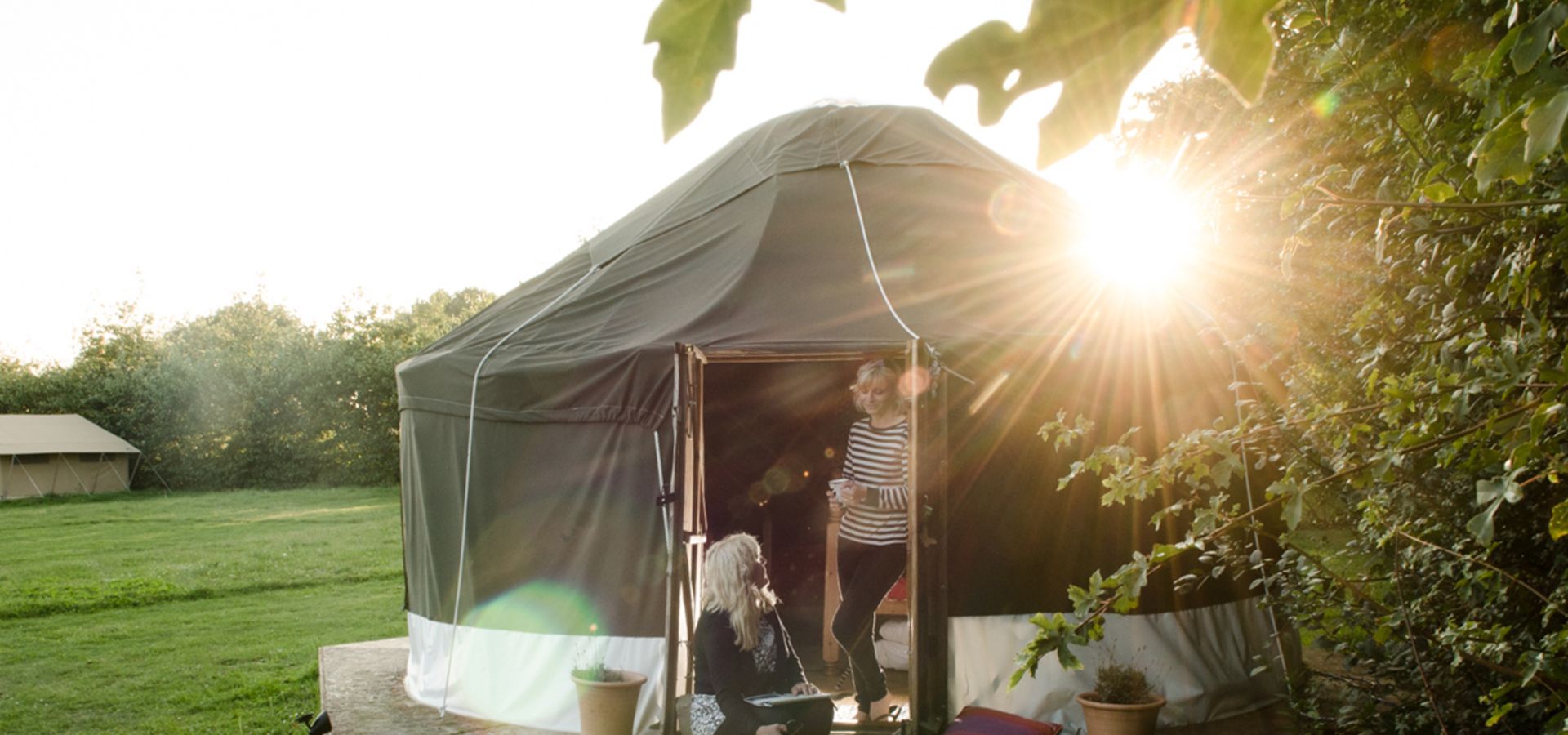 People stood outside glamping pod