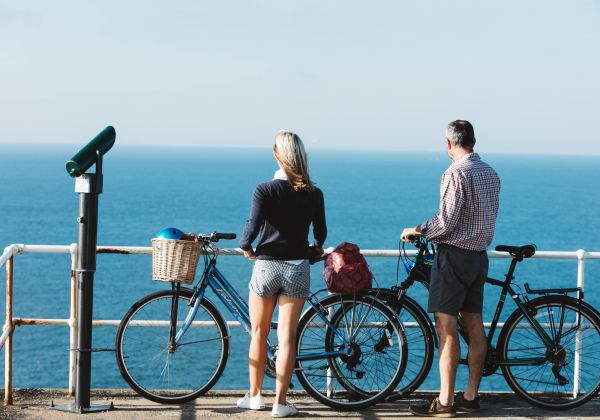 Couple cycling on the coast