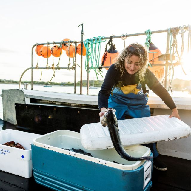 Young woman on a fishing boat in Gorey, Jersey