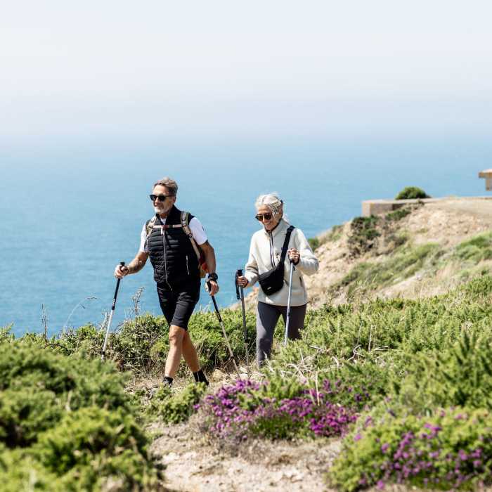 Older couple hiking on the headland at Battery Molke, Jersey