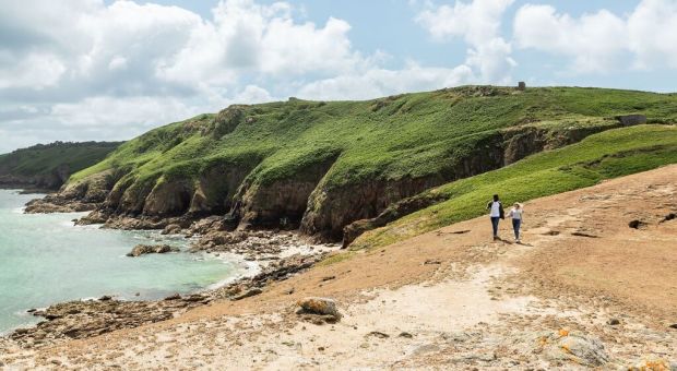Couple walking along the Jersey Tidal Trail, Plemont Jersey