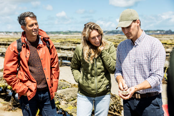 People chatting amongst oyster beds
