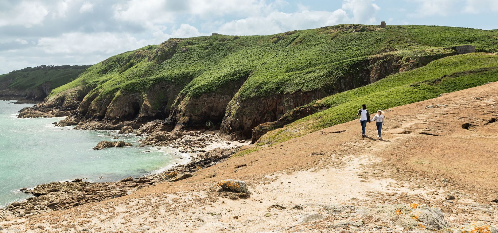Couple walking along the Jersey Tidal Trail, Plemont Jersey