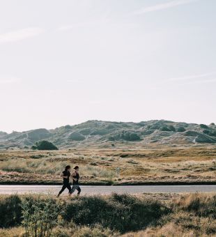 Two women running on St Ouen