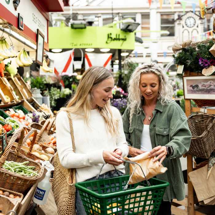 Two women shopping for vegetables in the Central Market, St. Helier