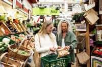 Two women shopping for vegetables in the Central Market, St. Helier