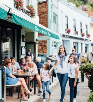 A family walking past the Dolphin in Gorey