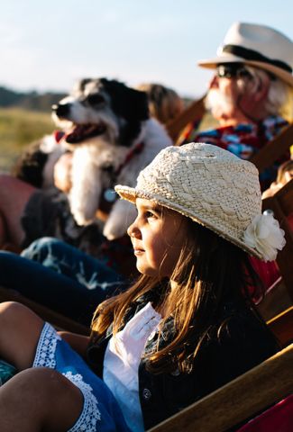 Family with dog on the beach at sunset in Jersey