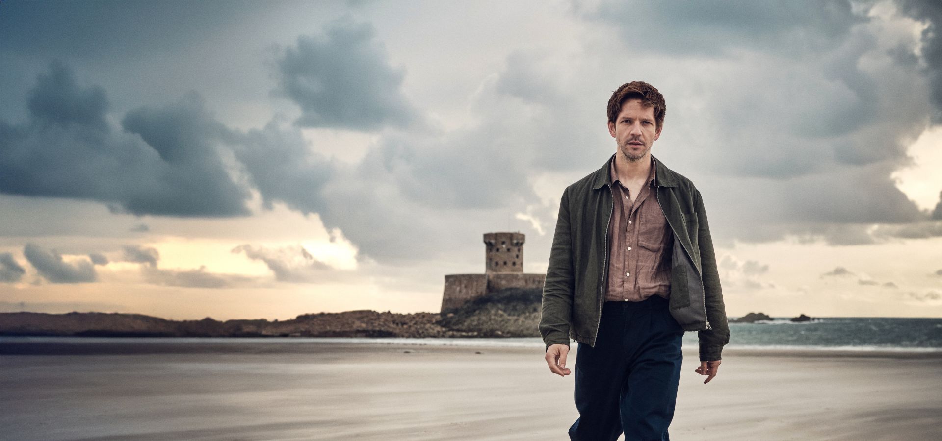 Bergerac actor Damien Molony walking along St. Ouen