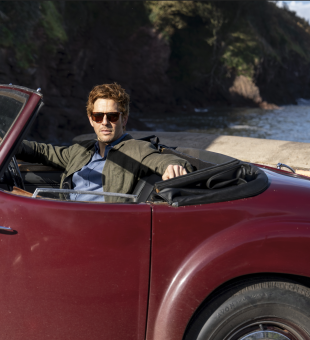 Bergerac star Damien Molony poses in the burgundy Triumph Roadster which appeared in the original Bergerac series
